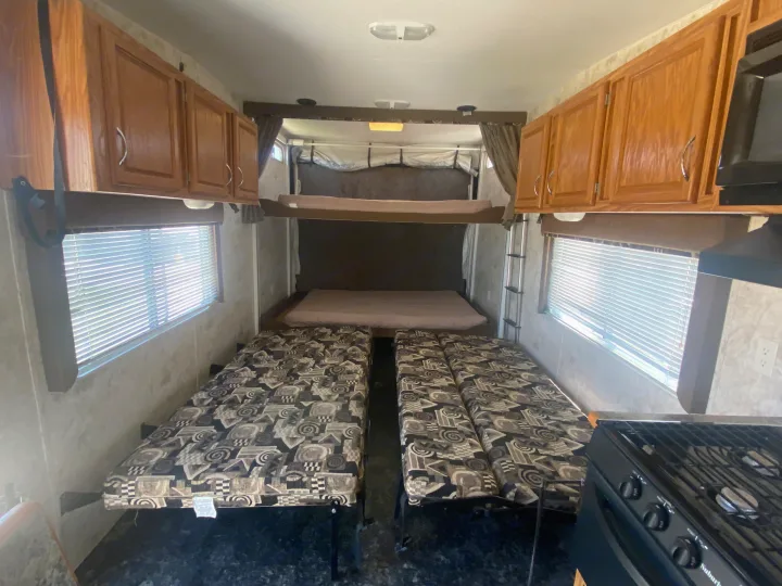 This RV rental interior features convertible seating, bunk beds, kitchen area, and storage cabinets for your trip.. Eclipse Recreational Vehicles Attitude 2006