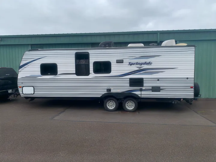 This white Springdale travel trailer RV is available for rv rental, featuring a spacious design for camping and travel adventures.. Keystone RV Springdale 2019