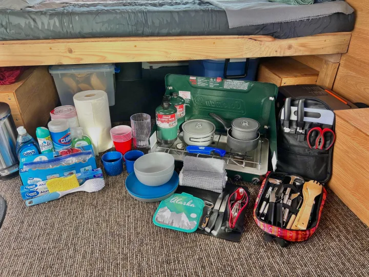 Organized rv rental camping kitchen setup: Coleman stove, pots, dishes, cleaning supplies & cooking tools ready for adventure.. Ford Econolline 250s 2006