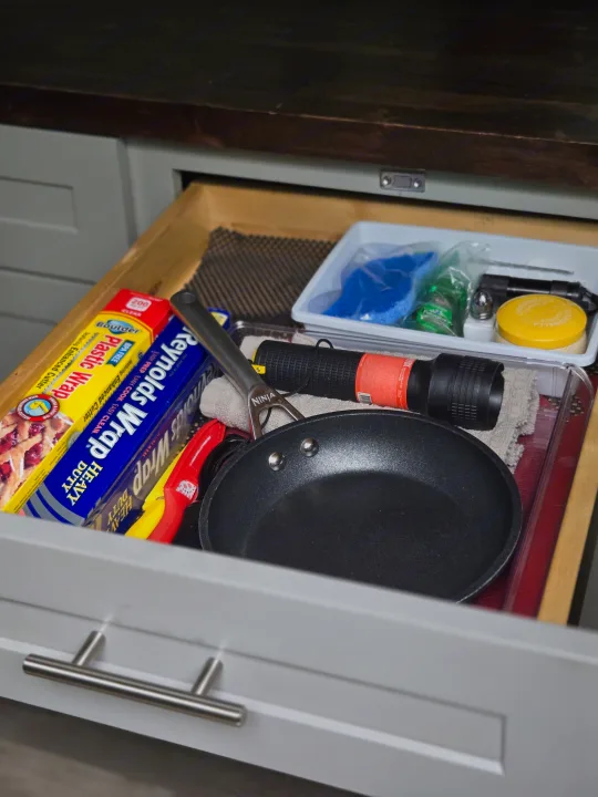 RV rental drawer storage: foil, plastic wrap, pan, flashlight, and small essentials like sponges and a citronella candle.. Freightliner Sprinter 2011