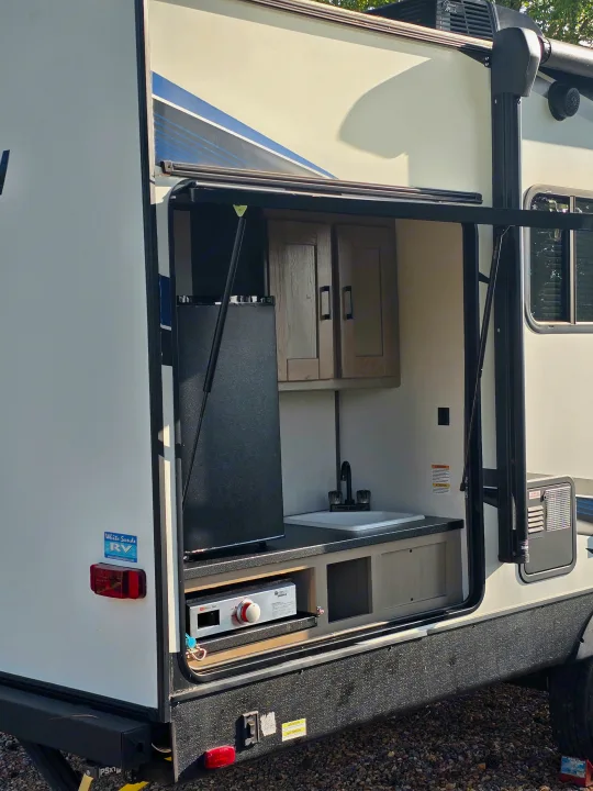 This RV rental features a convenient outdoor kitchen with a mini-fridge, sink, and pull-out griddle, perfect for camping.. Cruiser RV Shadow Cruiser 2021