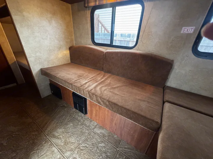 Step inside this cozy RV rental! Features an L-shaped dinette, window, and "EXIT" sign for safe travels.. Jayco Jay Flight Swift SLX 2012