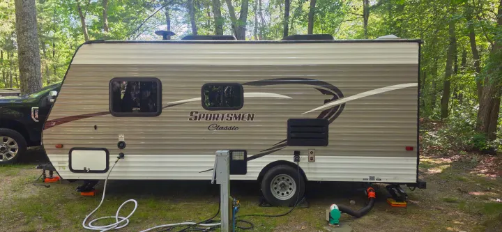 This RV rental is perfectly situated for a relaxing camping trip. Travel trailer, truck, and full utility hookups at a woodsy site.. KZ Sportsman Classic 180 QB 2018
