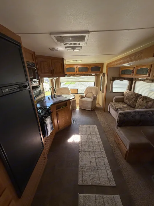 Step inside this inviting RV rental. Features a well-equipped kitchen, cozy living room, and reclining chairs.. Denali Denali Trailer 2011