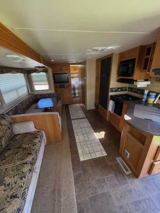 Cozy RV rental interior with kitchen, dinette, and living area. Ideal for your next road trip.. Denali Denali Trailer 2011
