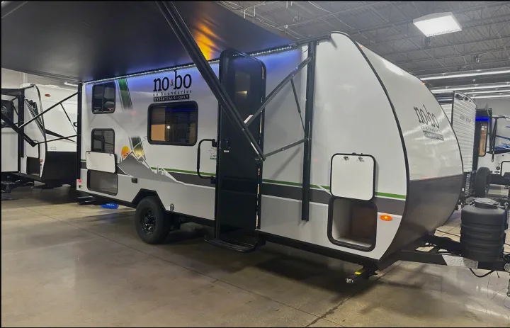 This no bo travel trailer is ready for RV rental adventures, featuring an extended awning with LED lights & storage.. Forest River No Bounderies 2024