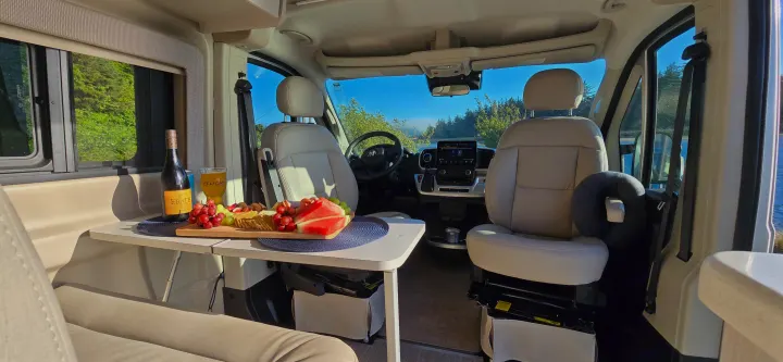 Scenic RV rental interior: A charcuterie spread with wine & beer, ready for adventure on the road.. Thor Tellaro 2024