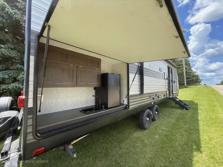 This rv rental has a convenient outdoor kitchen with sink, mini-fridge, and storage cabinets.. Forest River Salem 2019