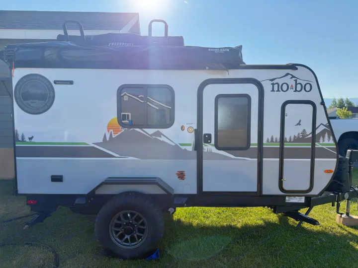 This rugged "No-Bo" travel trailer, equipped with a Freespirit rooftop tent and Rhino-Rack awning, is ideal for an rv rental adventure.. Forest River Nobo 10.7 2024
