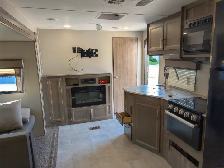 Spacious RV rental interior: modern kitchen, cozy living area with fireplace, and ample storage. Ready for your next adventure.. Forest River Coachmen Aurora 2022