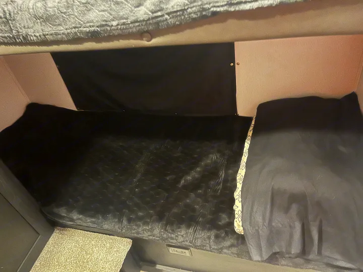 Inside this RV rental, find a compact bedroom with a TV, bed, and cozy comfort.. Coachmen 29SE 2022