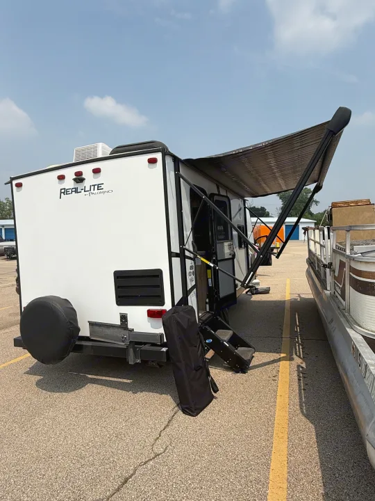White Real-Lite by Palomino travel trailer with extended awning and steps down. Perfect for your next rv rental.. Palomino Real Lite 2019