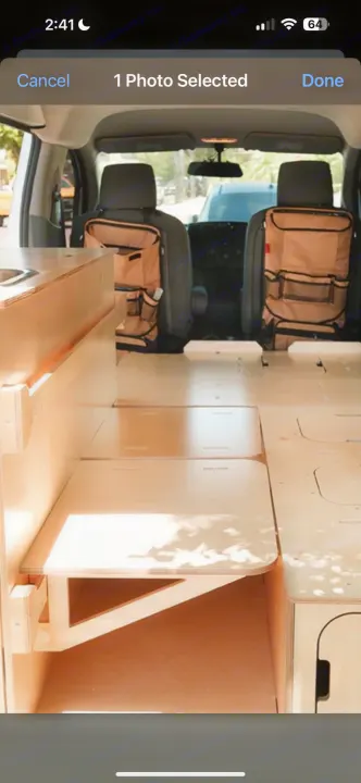 RV rental: Inside a camper van conversion, featuring light wood interior, modular bed, and seat back organizers.. Ram Promaster City 2018