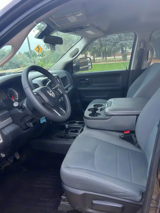 Inside a rental pickup truck: driver's side view showing the steering wheel, dashboard, seats, and center console, great for an RV rental trip.. Dodge Dodge 1 Ton Pu 2018