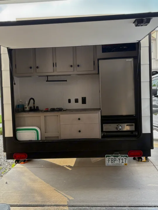 Fully equipped rear outdoor kitchen: with sink, fridge, flat top griddle, stovetop and lots of cabinets for camping convenience.. Forest River Viking 12000 2024