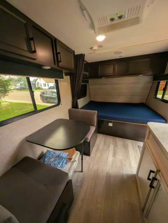 RV rental interior with dinette, bed, and cabinetry, offering a cozy living space.. Jayco Jay Flight SLX 2022
