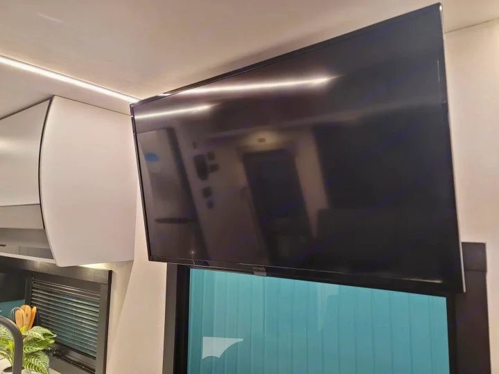 Enjoy entertainment in your RV rental! Modern interior features a high-mounted TV, sleek white cabinets, and ambient LED lighting.. Coachmen Euro 2025