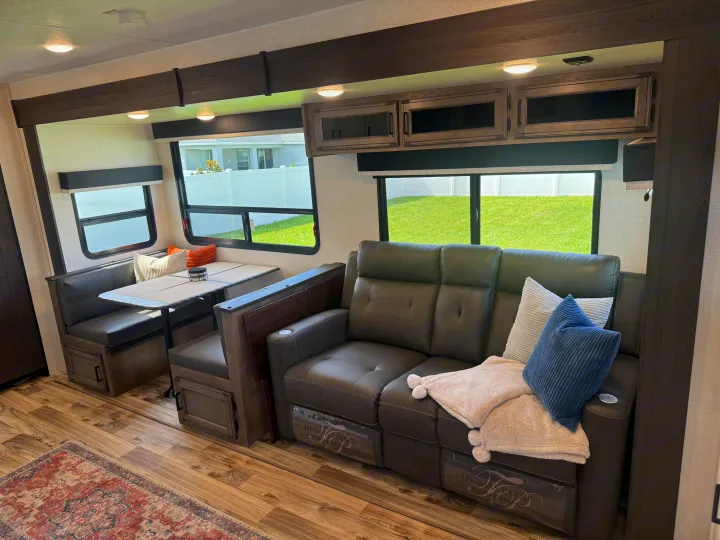 Spacious RV rental interior featuring a comfy sofa, dining area, and large windows for a relaxing recreational vehicle trip.. SportTrek Venture 2024