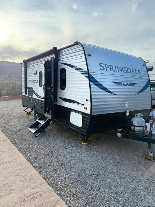 Silver Springdale travel trailer RV rental at a scenic campsite.. Keystone RV Springdale 2022