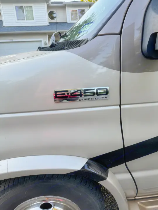 Close-up of an E-450 Super Duty RV rental's front side, showing its badge and two-tone finish.. Jayco Melbourne 2012