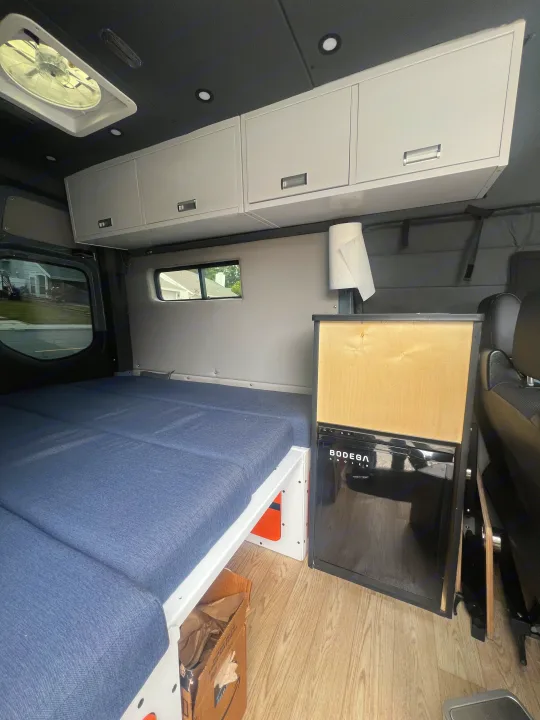 Step inside this cozy RV rental! Features a modular bed, sleek cabinets, and a BODEGA cooler, ready for your road trip.. Mercedes Sprinter 2021