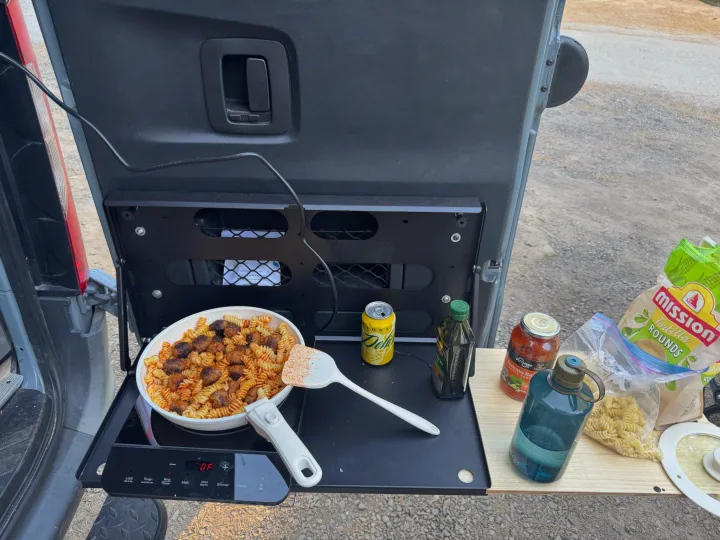 Enjoying an **RV rental** adventure with a delicious **camp kitchen** meal: pasta & meatballs cooked outdoors.. Mercedes Sprinter 2021