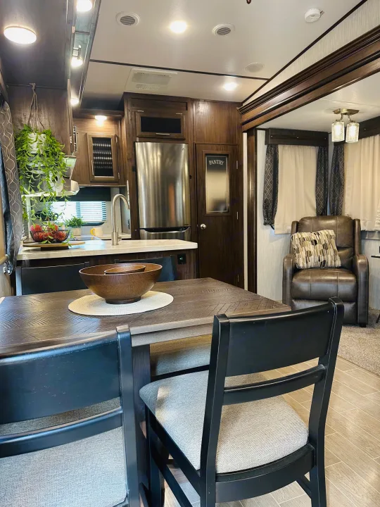 Experience comfort in this modern rv rental, featuring a full kitchen, dining area, and cozy living space with a recliner.. Forest River Cherokee Arctic Wolf 2019