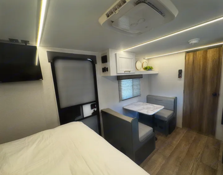 Step inside this cozy RV rental! Features a bed, dinette, TV, & modern amenities for a comfortable road trip.. Heartland RVs Eddie Bauer Edition 17RB-C 2025