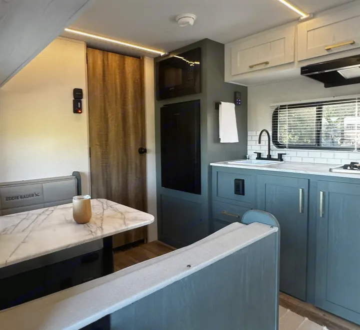 This RV rental showcases a bright, modern interior with a well-equipped kitchen and a cozy dining area.. Heartland RVs Eddie Bauer Edition 17RB-C 2025