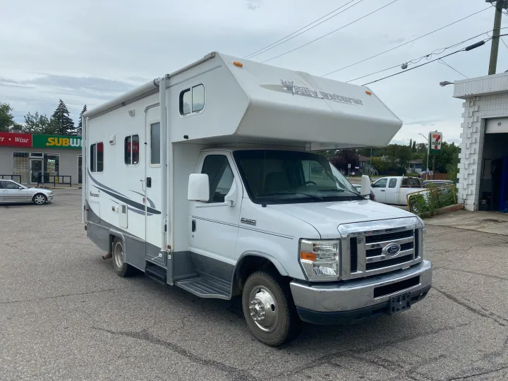 White Adventurer Class C RV (Ford E-350) parked near Subway/7-Eleven. This motorhome is an ideal rv rental.. Adventurer Adventurer Motorhome 2008