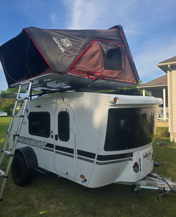 Teardrop RV rental: an InTech Rover trailer with an iKamper rooftop tent set up, complete with ladder, ready for adventure.. InTech RV Luna 2023