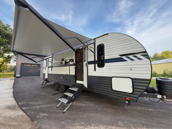 Spacious RV rental, parked with its awning extended and steps lowered, ready for your next outdoor adventure.. Gulf Stream Ameri-Lite 2023