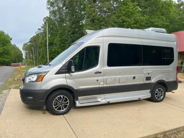 Sleek silver Airstream Rangeline RV rental parked on concrete, ready for your next journey.. Pleasure-Way Pleasure-Way Class B 2023