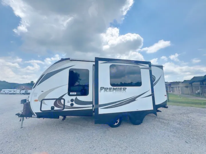Sleek white Premier travel trailer with extended slide-out. Ideal for your next RV rental adventure!. Keystone RV Bullet Ultra Lite 2014
