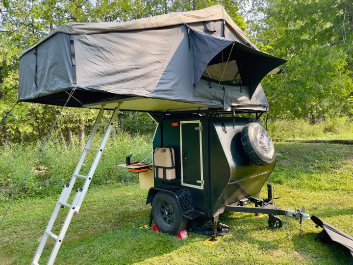 Compact teardrop camper with rooftop tent deployed, ready for your next RV rental camping adventure. Ideal outdoor living.. Nutshell Campers Nutshell Camper 2025