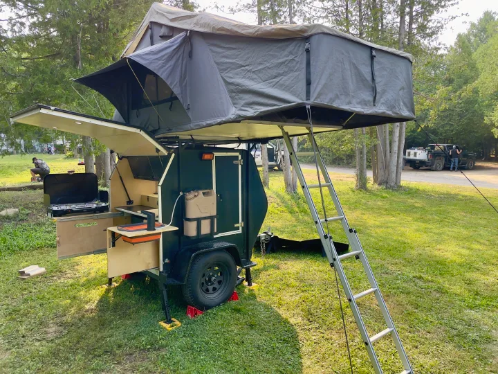 This RV rental shows a rugged camper trailer with a rooftop tent and an outdoor kitchen setup for camping adventures.. Nutshell Campers Nutshell Camper 2025