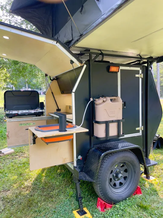Experience camping with this compact RV rental, a trailer with an open kitchen, sink, and rooftop tent.. Nutshell Campers Nutshell Camper 2025