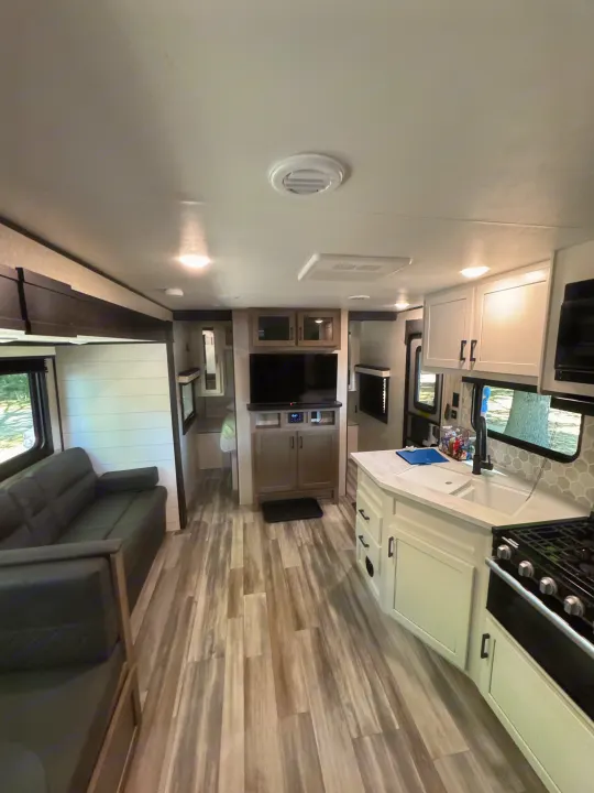 Spacious RV rental interior with modern living space, kitchen, and TV. Ideal for travel.. Jayco Jay Flight SLX 2024