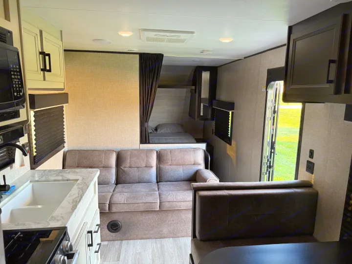 RV rental interior: A bright, modern space with kitchen, sofa, and private bunk beds, ready for your adventure.. Jayco Jay Flight SLX 2022