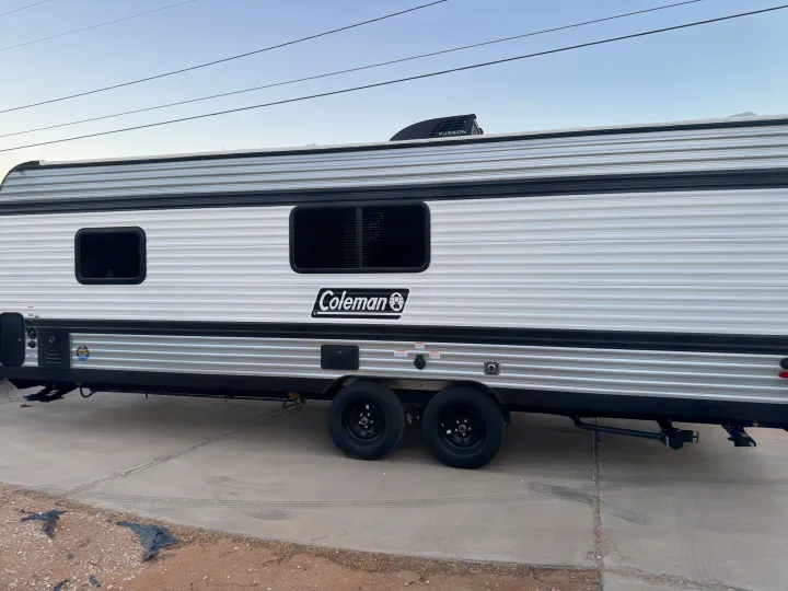 Modern Coleman travel trailer, great for RV rental adventures. Features dual axles and a Furrion A/C unit.. Colman 23B 2025