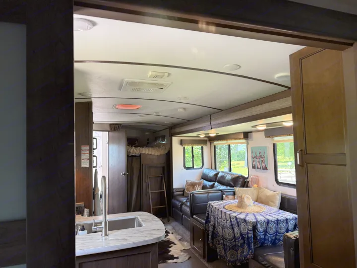 Spacious RV rental interior featuring a full kitchen, comfy living room, and bunk beds. Ideal for your next trip!. Keystone RV Passport Grand Touring 2020