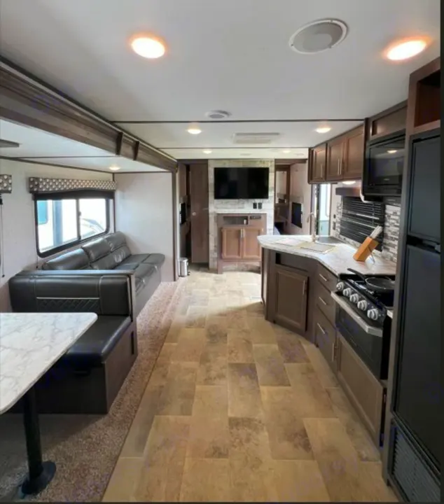 Spacious rv rental interior with modern kitchen, comfy sofa, and dinette. Perfect for family travel adventures.. Dutchmen Coleman Lantern LT 2020