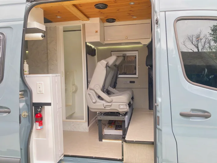 Modern RV rental interior: sleek camper van conversion with seating, kitchen, bathroom, and amenities.. Mercedes Sprinter 2500 4x4 2021