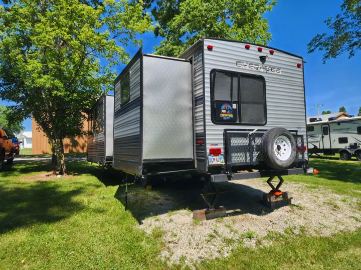 A large gray travel trailer RV rental, parked with slides extended, ready for a sunny camping adventure.. Forest River Cherokee 2019