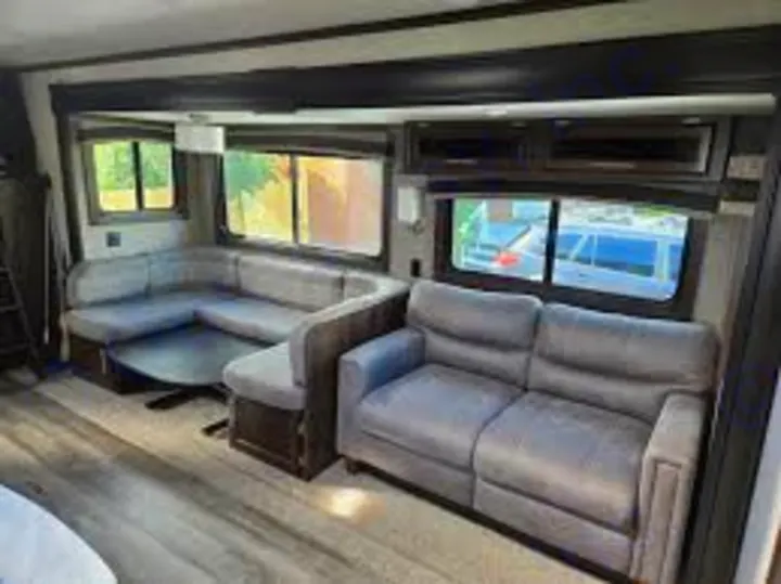 Experience comfort in this RV rental's spacious living area. Features include a large U-shaped dinette and plush sofa.. Jayco Jay Flight 2019