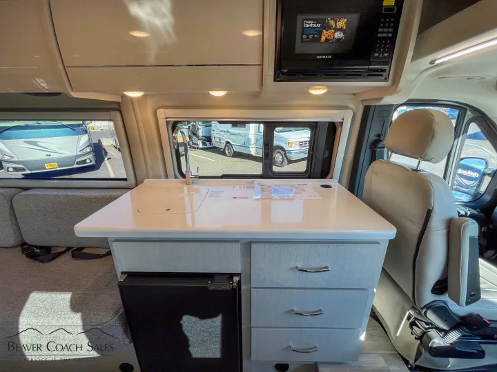 RV rental: Modern Thor camper van interior features a Contoure microwave, sink, and comfortable seating.. Thor Tellaro 2026