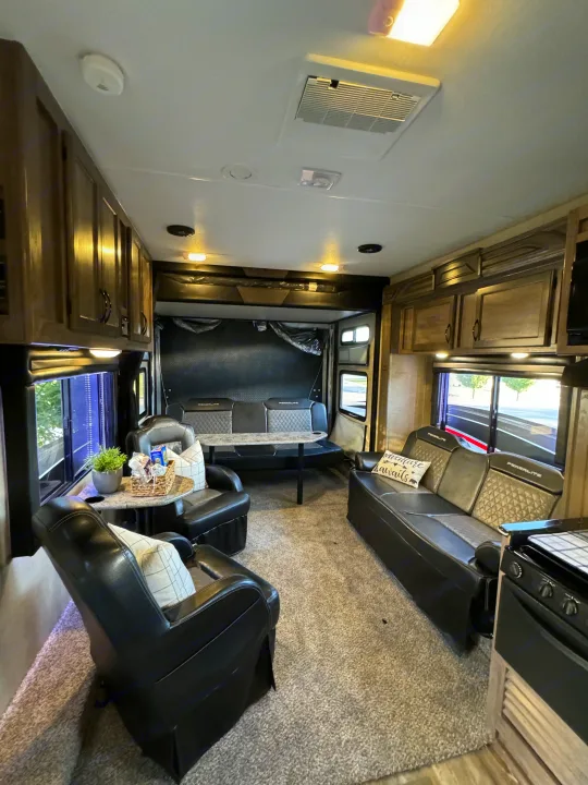 Comfortable RV rental interior with recliners, a dinette table, and spacious living area for your travels.. Pacific Coachworks Powerlite 2017
