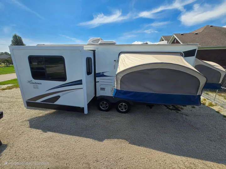 A white Coachmen pop-up RV for rv rental, with tent ends extended, is parked on a gravel lot. Ideal for camping adventures.. Coachmen Freedom express ltz 2014