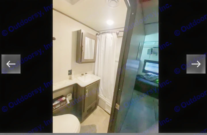 RV rental bathroom features: compact shower, toilet, sink. Bedroom visible through doorway, highlighting functional RV interior.. Coachmen Lantern 2021