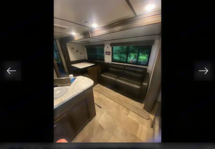 Bright and modern RV rental interior with a spacious dinette, comfortable sofa, and kitchen area for your trips.. Coachmen Lantern 2021